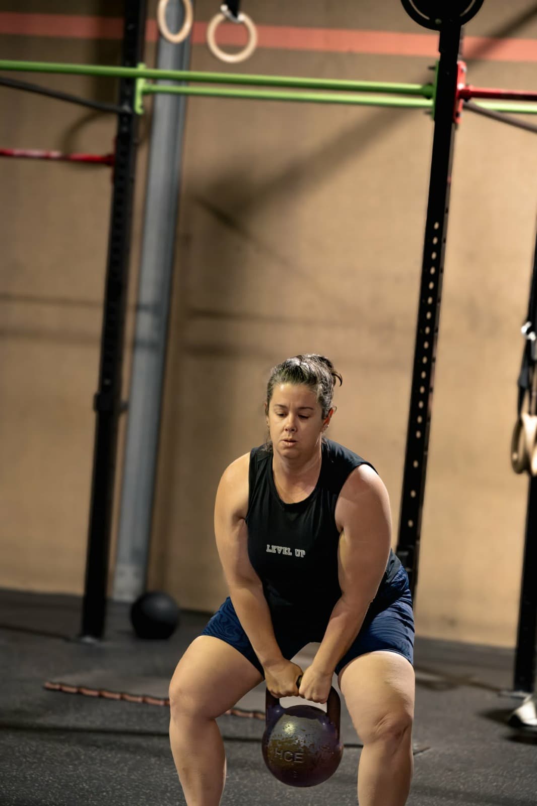 Tracey swinging a kettlebell during a class at The Bar