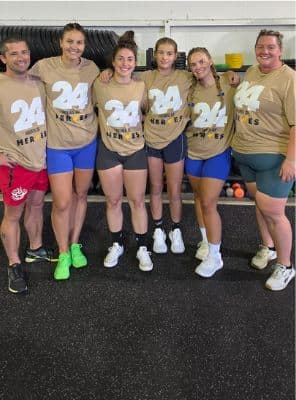 A group of members smiling together after a workout